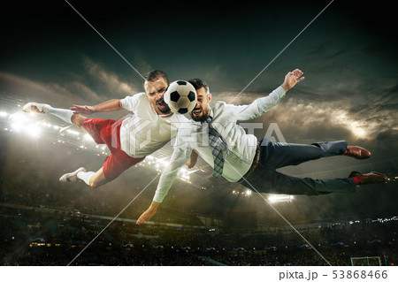 Office man as a soccer or football player at the stadium Office man as a soccer or football player at the stadium 53868466