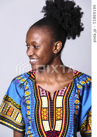 Young african woman in blue dress looks sideways Young african woman in blue dress looks sideways 53869190