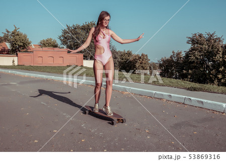 Beautiful woman, athletic hipster girl summer city ride skateboard, lifestyle, fashion modern trend Beautiful woman, athletic hipster girl summer city ride skateboard, lifestyle, fashion modern trend 53869316