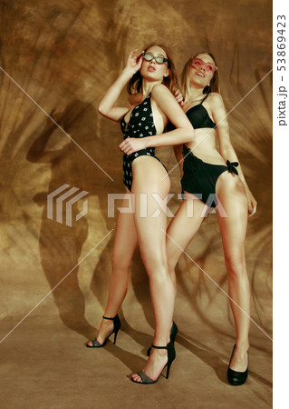 Beautiful girls isolated on braun studio background 53869423