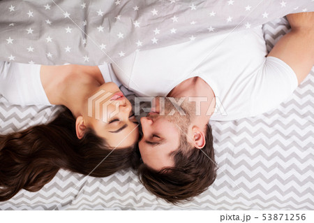 Happy couple having fun in bed. Intimate sensual young couple in bedroom enjoying each other Happy couple having fun in bed. Intimate sensual young couple in bedroom enjoying each other 53871256