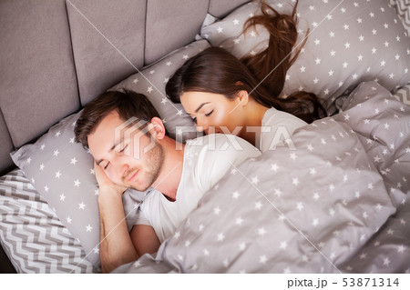 Happy couple having fun in bed. Intimate sensual young couple in bedroom enjoying each other 53871314