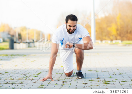 Healthy lifestyle. Fitness man doing exercise in city environment 53872265