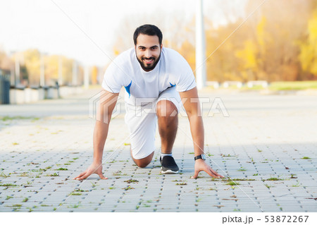 Healthy lifestyle. Fitness man doing exercise in city environment 53872267