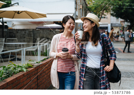 happy girls talking and carry coffee to go 53873786