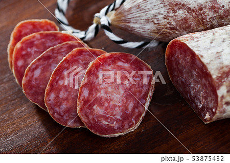 Spanish longaniza salami sausages cut in slices on a woodefn desk 53875432