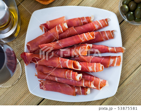 Rolled up slices of dry-cured ham Rolled up slices of dry-cured ham 53875581