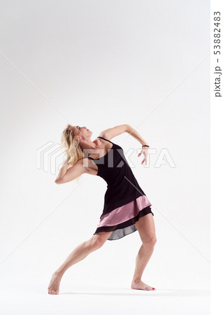 Photo of dancing woman looking away in short black dress Photo of dancing woman looking away in short black dress 53882483