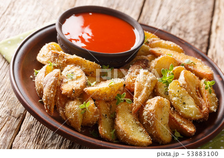 Fried potato wedges with parmesan and herbs with 53883100
