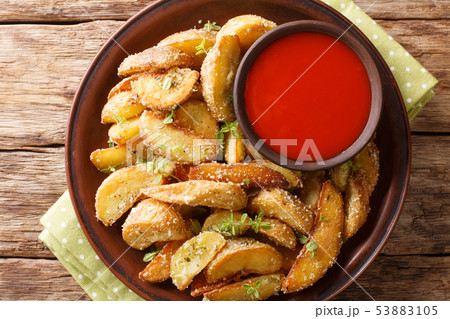 Delicious baked potato wedges with parmesan and Delicious baked potato wedges with parmesan and 53883105