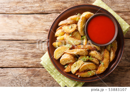 Fried potato wedges with parmesan and herbs with Fried potato wedges with parmesan and herbs with 53883107