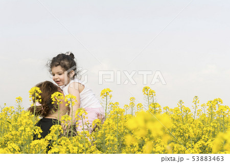 Mother with her little girl having fun at canola 53883463