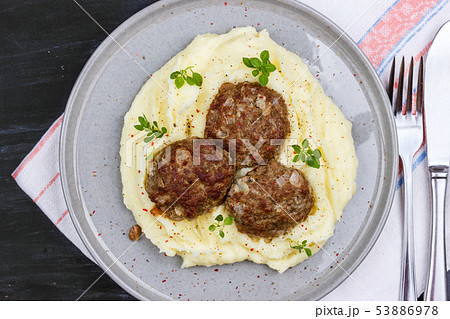 Mashed potatoes and meat balls on a gray plate, 53886978
