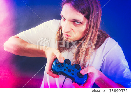 Stressed man playing on pad Stressed man playing on pad 53890575