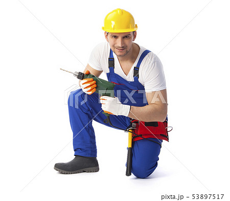 Smiling handyman holding drill machine 53897517