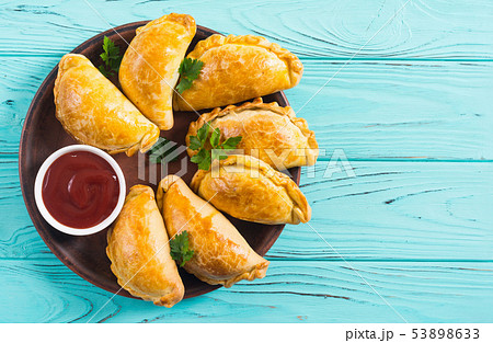 Latin American baked beef empanadas with sauce 53898633
