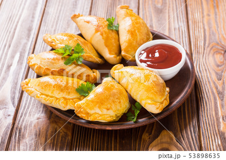 Latin American baked beef empanadas with sauce 53898635