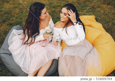 Two pretty girls in a summer park 53899704