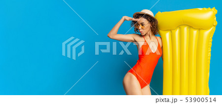 Cute african woman in swimwear looking away at copy space Cute african woman in swimwear looking away at copy space 53900514
