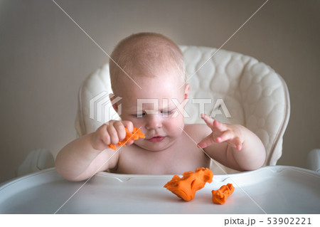 Children creativity. the baby is trying to sculpt from clay. Cute little boy mould from plasticine Children creativity. the baby is trying to sculpt from clay. Cute little boy mould from plasticine 53902221