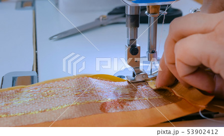 Professional tailor, fashion designer sewing clothes with sewing machine 53902412
