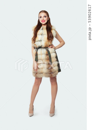 Fashion woman standing against white wall 53902617