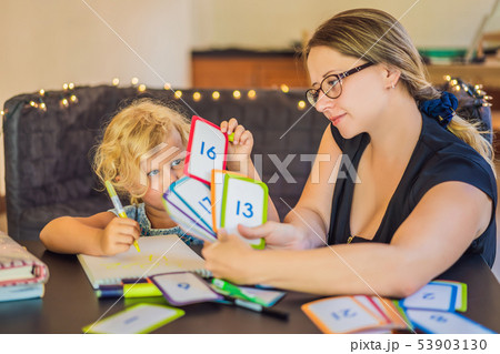 A teacher, a tutor for home schooling and a teacher at the table. Or mom and daughter. Homeschooling A teacher, a tutor for home schooling and a teacher at the table. Or mom and daughter. Homeschooling 53903130