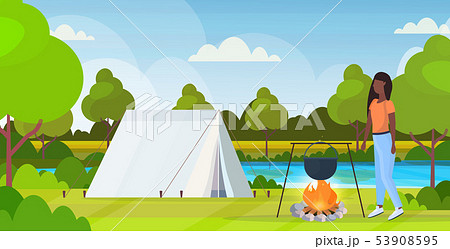 woman hiker preparing food in bowler boiling pot at campfire hiking concept african american 53908595