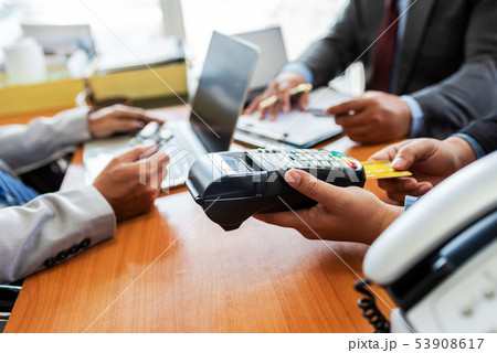 Group of business holding credit card with NFC Group of business holding credit card with NFC 53908617