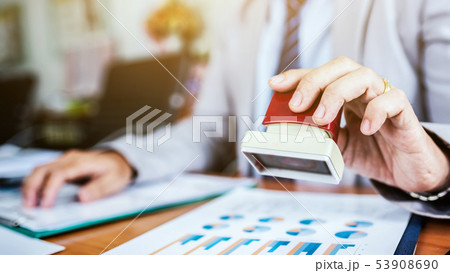 Business man hand stamp document paper for 53908690
