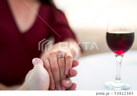 Couple holding hands on a date 53912365