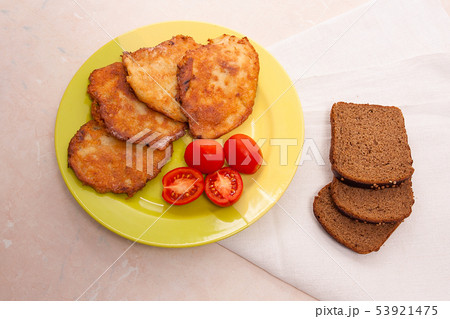 Potato pancakes with meat and tomatoes on green Potato pancakes with meat and tomatoes on green 53921475