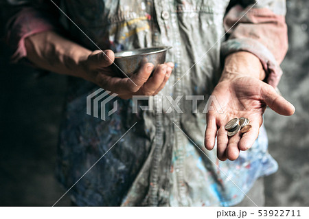 Male beggar hands seeking money on the wooden floor at public path way Male beggar hands seeking money on the wooden floor at public path way 53922711