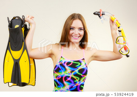 Woman with flippers and snorkeling mask having fun Woman with flippers and snorkeling mask having fun 53924419
