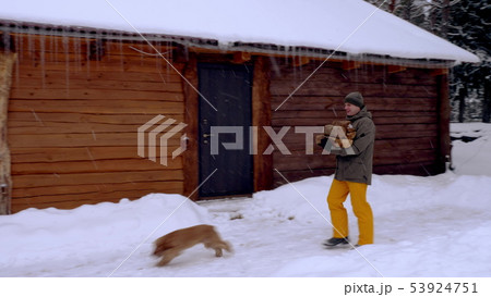 Man carries firewood on his hands 53924751