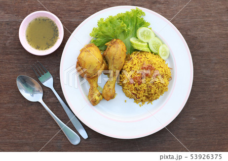 Muslim yellow rice with chicken in a white plate 53926375