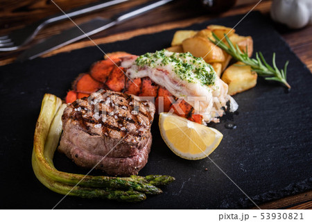 surf and turf on black stone plate surf and turf on black stone plate 53930821