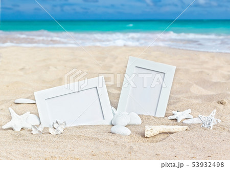 Seascape with two photo frames on the beach sand Seascape with two photo frames on the beach sand 53932498
