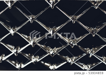 Grid of car with sunflare. Radiator grille. Metal close-up texture background. Chrome grill of big Grid of car with sunflare. Radiator grille. Metal close-up texture background. Chrome grill of big 53934859