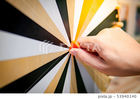 Male hand spinning wooden wheel of fortune 53940140