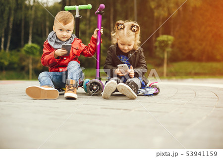 Cute child in a park playing on a grass 53941159