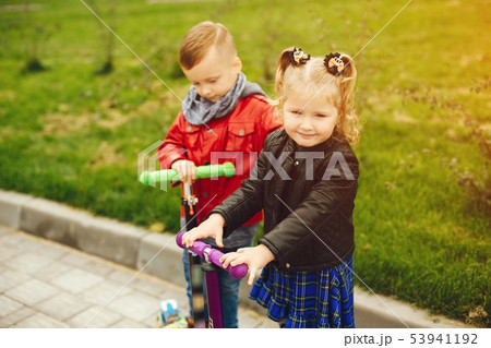 Cute child in a park playing on a grass Cute child in a park playing on a grass 53941192