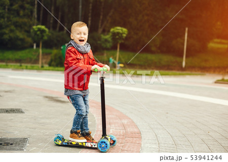 Cute child in a park playing on a grass Cute child in a park playing on a grass 53941244