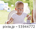 Portrait of a baby eating with a stained face. 53944772