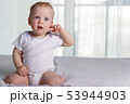 Playful little boy on the bed against window background 53944903