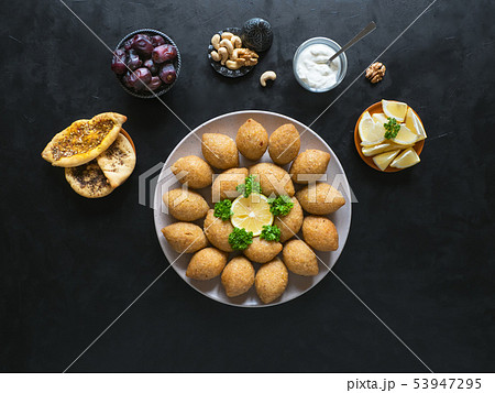 Traditional Arabic kibbeh with lamb and pine nuts. Traditional Arabic kibbeh with lamb and pine nuts. 53947295