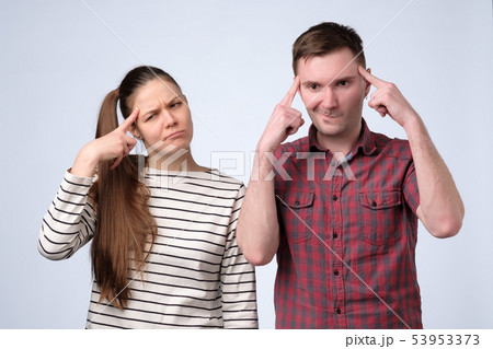 Young couple thinking puzzled about their family budget 53953373
