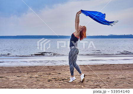 Slim red-haired middle-aged woman in sports form Slim red-haired middle-aged woman in sports form 53954140