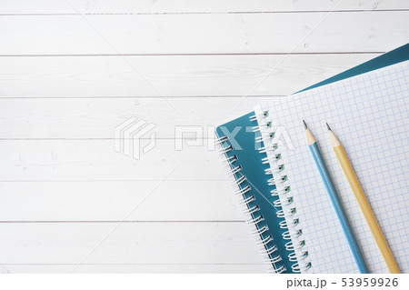 Clean white notebook and pencil with copy space  53959926