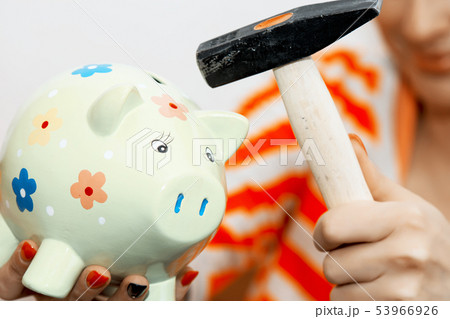 Breaking a piggy bank with a hammer 53966926